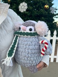 a person holding a stuffed animal in their hands