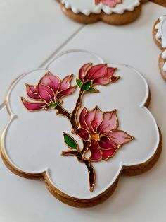 some cookies decorated with flowers and leaves on a table