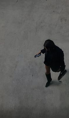 a person riding a skateboard on top of cement