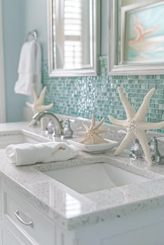 two starfishs are sitting on the edge of a bathroom sink