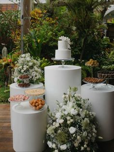 a table topped with lots of cakes and flowers