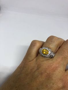 Vintage Golden Citrine Ring Deco 925 Sterling Silver Unusual cut of citrine surrounded by white sapphire Sterling Filigree finished Setting Handmade Size 7 Can be resized by my jeweler for a $10-$20 jeweler's fee All rings are shipped free in the US in a nice gift box. Check out our over a THOUSAND great reviews Engraving is $4 per letter and is not always perfect depending on the piece. It can take a few days if the jeweler is busy. This is payable to Paypal Judithsltd@gmail.com Yellow Sapphire Ring With Diamond Accent Stones, Yellow Diamond Gemstones For Anniversary, White Gold Citrine Jewelry With Halo Setting, Yellow Sapphire Diamond Ring With Accent Stones, White Gold Citrine Jewelry With Center Stone, White Gold Citrine Diamond Ring With Accent Stones, White Gold Diamond Ring With Citrine Accent Stones, Yellow Center Stone Gemstone For Anniversary, Oval Yellow Sapphire Jewelry With Center Stone