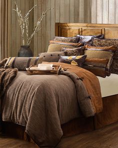 a bed with brown and tan comforters in a bedroom