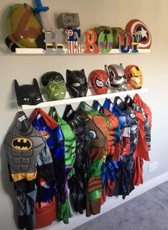 there are many different costumes on the shelves in this room, including batman and hulk