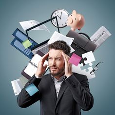 a man is holding his head in front of many different items that are on top of him