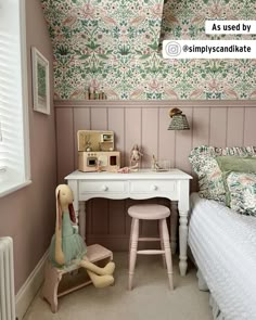 a bedroom with pink walls and floral wallpaper on the walls is decorated in pastel tones