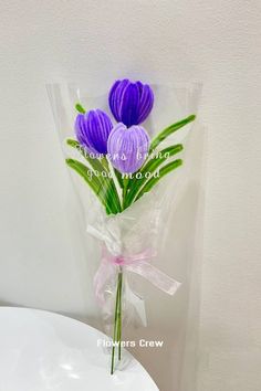 a bouquet of purple crocsants wrapped in cellophane