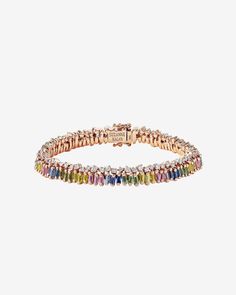 Discover a modern take on a timeless classic with this stunning short stack rainbow sapphire tennis bracelet from SUZANNE KALAN. The bracelet has been designed to add a touch of glamour and sophistication to any outfit, with 7.86 carats of vertically staggered baguette pastel sapphires set on top of a row of unevenly set round white diamonds in a unique interpretation of our signature setting. Details 18k rose gold or yellow gold 7.68 carats of baguette pastel sapphires 1.77 carats of round whit Luxury Multi-stone Cubic Zirconia Tennis Bracelet, Luxury Cubic Zirconia Multi-stone Tennis Bracelet, Luxury Multicolor Baguette Diamond Jewelry, Fine Jewelry With Multicolor Baguette Diamonds, Sapphire Tennis Bracelet, Short Stack, Rainbow Sapphires, Suzanne Kalan, Tennis Bracelet