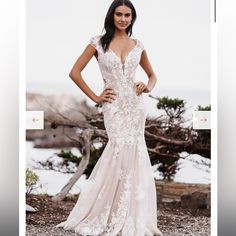 a woman in a wedding dress posing for the camera with her hands on her hips