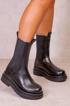 Women's calf boots featuring a chunky stacked platform with sole pull on Chelsea boots.