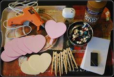 craft supplies are arranged on a table to make valentine's day decorations