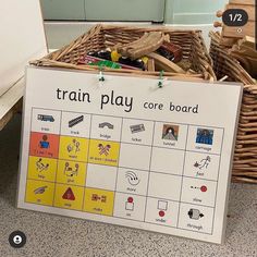 a sign that says train play core board next to some baskets with toys in them