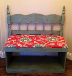 a wooden bench with a red cushion on it