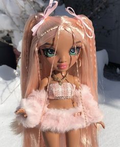 a close up of a doll in the snow