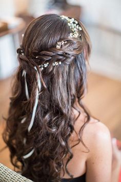 the back of a woman's head with flowers in her hair