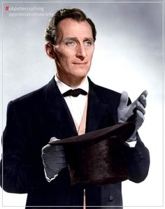 a man in a tuxedo holding a top hat