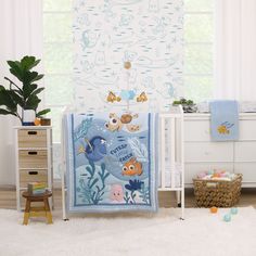 there is a baby crib bedding set with fish and sea animals on it