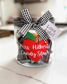 a jar filled with lots of candy sitting on top of a table