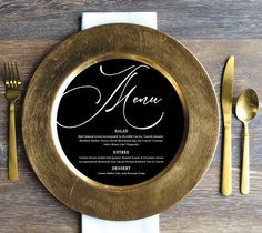 a gold plate with a black menu on it next to silverware and golden utensils