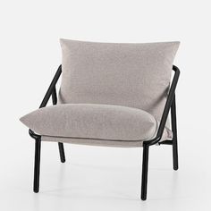 a gray chair with black legs and a light colored pillow on the armrests