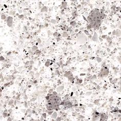 an image of a white marble surface with black dots on the bottom and grey spots on the top