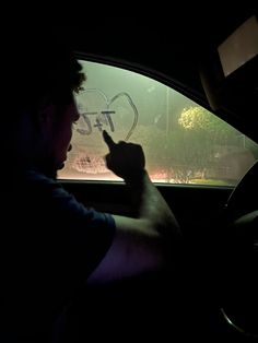 a man sitting in the back seat of a car holding a cell phone