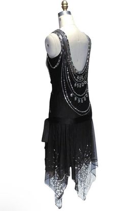 "Stunning Jet Black Vintage Charleston Flapper 1920's inspired beaded and sequinned wedding Dress.  Inspired by the films of Ginger Rodgers and Fred Astaire, our Socialite gown is an ethereal work of art. Handbeaded on decadent tulle, it is loaded with luxurious rhinestones and pearls....plus the highest quality Czech crystal beads.    A draped handkerchief hem and silk hip sash complete the look.  Satin underslip included. Please send your Bust,  Waist,  and hip measurements with your order. Si Beaded Wedding Dress Vintage, 1928 Fashion, 20s Clothing, Dance Decor, Gatsby Dresses, Crystal Gown, Deco Dress, Black Jet, Gown Black