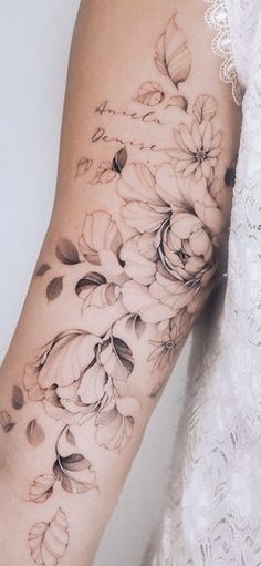 a woman's arm with flowers on it