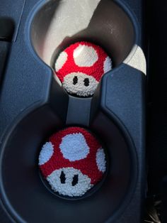 two red and white crocheted mario mushroom balls