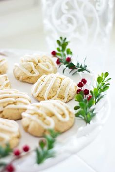 cookies with icing and sprigs on a white plate