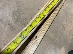 two pieces of wood with measuring tape on them