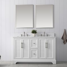 two white double sinks with mirrors above them