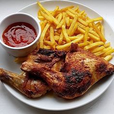 a white plate topped with chicken, french fries and ketchup