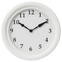 a white wall clock with black numbers on the face and hands, isolated against a white background