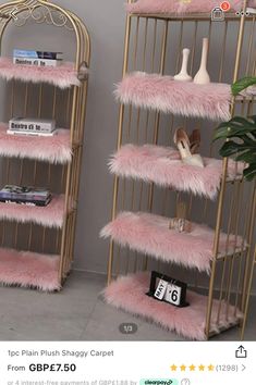 two gold shelves with pink fur on them