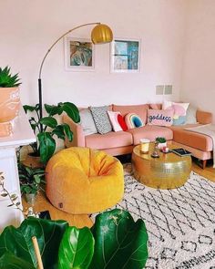 a living room filled with lots of furniture and plants