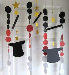 three mobiles with hats and stars hanging from them