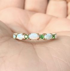 Opal and Emerald Half Eternity Band Ring. MaterialSolid Gold (14K/18K) or Platinum 950 FinishingHigh Polished/Shiny PlatingRhodium/Platinum Family (Only if white gold selected) FitStandard Width3.2 mm Height3 mm SettingProng Stone #1Natural Opal ShapeOval Size3mm x 5mm Quantity5 Opals ColorWhite with Fire-like hues of Orange, Yellow and Red Stone #2Natural Emerald QualityAAA CutRound, Diamond Cut Size2mm Quantity4 Emeralds Click below to add laser engraving. https://www.etsy.com/listing/63107091 Elegant 14k Gold Multi-stone Eternity Band, Oval Half Eternity Band For Formal Occasions, Oval Yellow Gold Emerald Ring With Multiple Stones, Oval Yellow Gold Emerald Ring With Multi-stone, Heirloom Oval Opal Ring With Multi-stone, Oval White Gold Half Eternity Band, Oval Half Eternity Band In White Gold, Green Gemstone Eternity Band For Wedding, Oval Opal Ring With Prong Setting