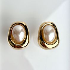 Vintage 90s Bijoux Givenchy Earrings Glass Pearl Polished Gold Plated Modernist Minimalist Clip On SIGNED. Gorgeous Vintage 90s Bijoux Givenchy Clip On Earrings. A Minimalist Aesthetic By Givenchy. These Lovely Earrings Feature A Unique Modernist Shape Finished In Polished Gold Plating. An Oval Shaped Glass Pearl Sits Center. Made Of Gold Plating With Classic Clip On Style Backs. Givenchy Always Does It Right. A Perfect Classic Earring To Compliment Your Wardrobe Looks. These Are Beautiful Earrings. SIGNED Preowned Vintage Condition. Shows Signs Of Lite To Mild Vintage Wear Primarily Some Surface Wear, Lite Scratches Or Marks. Great Vintage Condition. Classic Metal Clip-on Earrings, Chic Formal Metal Clip-on Earrings, Minimalist Metal Clip-on Earrings For Formal Occasions, Luxury Metal Clip-on Earrings For Formal Occasions, Classic Metal Clip-on Earrings For Evening, Givenchy Earrings, Classic Earrings, Lovely Earrings, Minimalist Aesthetic