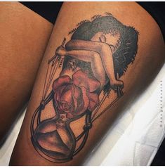 a woman holding an hourglass with a rose on her thigh and another tattoo design