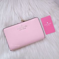 Color: Chalk Pink Material: Saffiano Leather Condition: Brand New With Tag Style Number: Wlr00128 Dimension: 4.5" H X 5.5" W X 1" D Ksny Metal Pinmount Logo Two Way Spade Jaquard Lining Interior: 8 Credit Card Slots, Id Window, 4 Slip Pockets, 2 Bill Folds Exterior: L-Zip Coin Compartment Snap Closure Dust Bag Not Included This Medium Wallet Holds All Your Credit Cards, Bills, Loose Change, I.D., Receipts, Ticketsand It Won't Take Up All The Space In Your Bag. 100% Authentic Comes From Clean Sto Kate Spade Pink Bifold Wallet, Chic Kate Spade Bifold Wallet, Formal Pink Kate Spade Wallets, Kate Spade Pink Leather Wallet, Formal Kate Spade Clutch, Kate Spade Staci, Dream Bag, Loose Change, Cleaning Storage