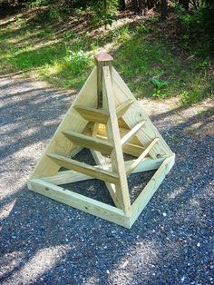 a wooden triangle on the side of a road