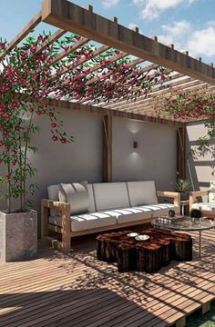 an outdoor living area with couches, tables and flowers on the pergolated roof