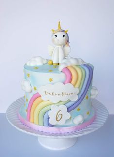 a birthday cake with a unicorn on top