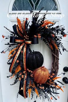 a wreath that has two pumpkins on it