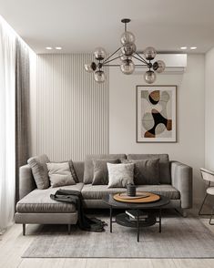 a living room filled with furniture and a chandelier hanging over the top of it