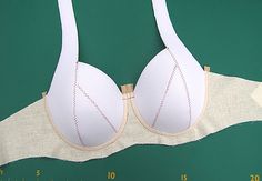 a white bra is shown on a ruler