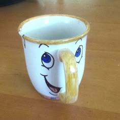 a coffee cup with a smiley face painted on it