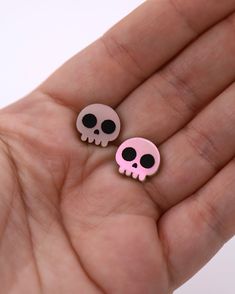 Unveil a daring side with our Skull Stud Earrings - a timeless and audacious design destined to stand out in any ensemble. Whether you're celebrating the spookiness of Halloween, attending a themed event, or just in the mood for some skull flair, these earrings are the perfect pick. Each pair showcases intricately engraved eyes and nose, enhanced by meticulous hand-painting. Available in various striking colors, from the mysterious Black with contrasting white regards, the luminous Green Glow-in Edgy Pink Party Jewelry, Pink Skull Jewelry For Halloween, Pink Punk Halloween Jewelry, Punk Skull Earrings For Party, Edgy Pink Jewelry For Gifts, Edgy Pink Jewelry For Gift, Edgy Skull-shaped Earrings For Gift, Edgy Skull Shaped Earrings For Gift, Edgy Skull Earrings For Parties