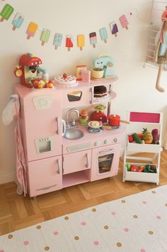 a child's play kitchen with ice cream on the wall